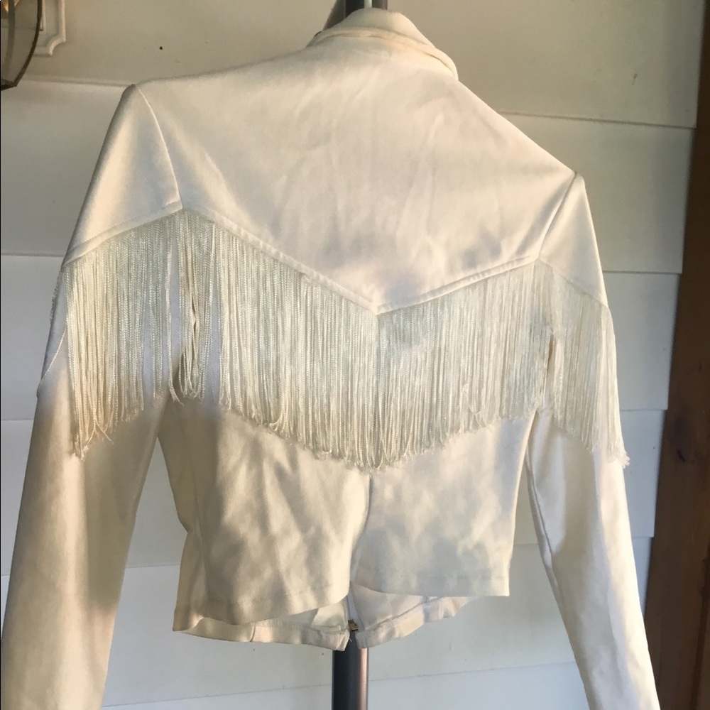 Short white fringed jacket.